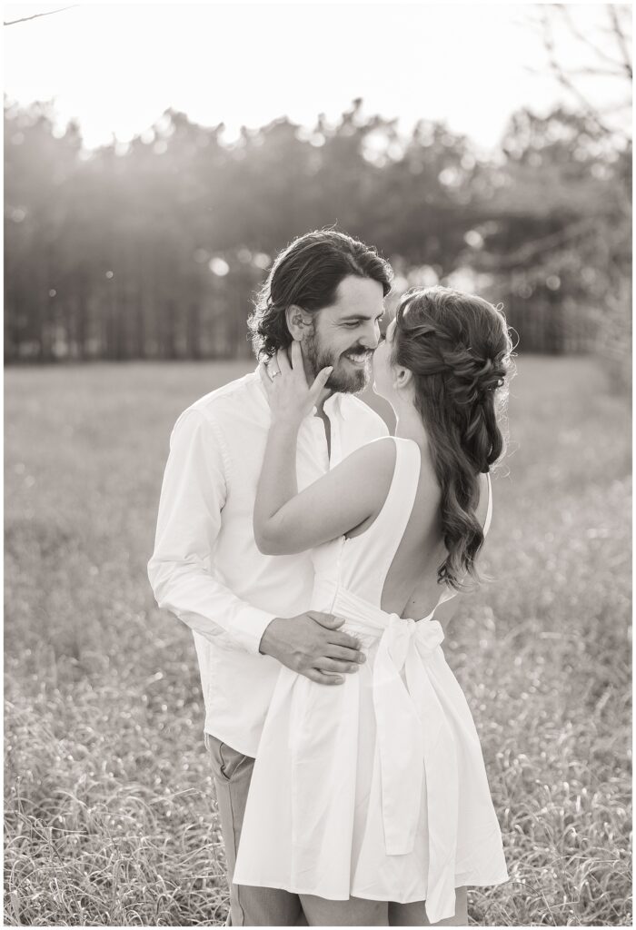"Houston wedding photographer capturing a bride and groom during sunset portraits."

"Photographer in action at a Houston wedding ceremony, taking candid shots of the couple."
"Engaged couple holding hands and walking through a sunlit field at golden hour."

"Man lifting fiancée playfully while laughing during an engagement session."

"Close-up of couple’s hands showing off the engagement ring."

"Couple embracing in front of a scenic city skyline during their engagement session."

"Engaged couple sharing a kiss under a tree with fall leaves surrounding them."
"Engagement session in downtown Houston with couple standing in front of skyline views."

"Couple holding hands while walking through a park in Houston during sunset."

"Engaged couple posing by the water at Hermann Park in Houston."

"Romantic engagement session in a peach orchard near Houston, with soft evening light."