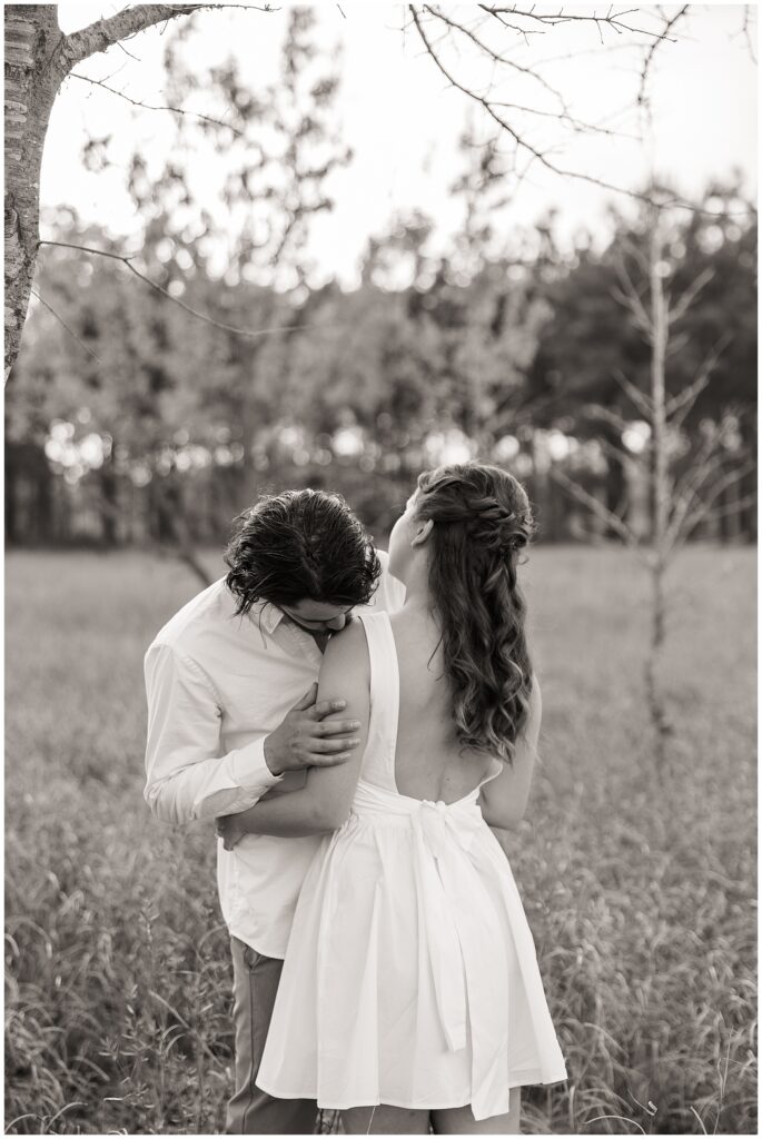 "Houston wedding photographer capturing a bride and groom during sunset portraits."

"Photographer in action at a Houston wedding ceremony, taking candid shots of the couple."
"Engaged couple holding hands and walking through a sunlit field at golden hour."

"Man lifting fiancée playfully while laughing during an engagement session."

"Close-up of couple’s hands showing off the engagement ring."

"Couple embracing in front of a scenic city skyline during their engagement session."

"Engaged couple sharing a kiss under a tree with fall leaves surrounding them."
"Engagement session in downtown Houston with couple standing in front of skyline views."

"Couple holding hands while walking through a park in Houston during sunset."

"Engaged couple posing by the water at Hermann Park in Houston."

"Romantic engagement session in a peach orchard near Houston, with soft evening light."