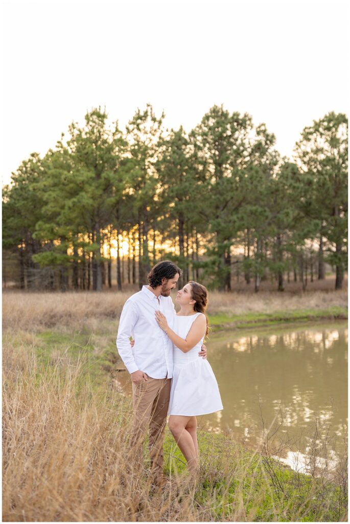 "Houston wedding photographer capturing a bride and groom during sunset portraits."

"Photographer in action at a Houston wedding ceremony, taking candid shots of the couple."
"Engaged couple holding hands and walking through a sunlit field at golden hour."

"Man lifting fiancée playfully while laughing during an engagement session."

"Close-up of couple’s hands showing off the engagement ring."

"Couple embracing in front of a scenic city skyline during their engagement session."

"Engaged couple sharing a kiss under a tree with fall leaves surrounding them."
"Engagement session in downtown Houston with couple standing in front of skyline views."

"Couple holding hands while walking through a park in Houston during sunset."

"Engaged couple posing by the water at Hermann Park in Houston."

"Romantic engagement session in a peach orchard near Houston, with soft evening light."