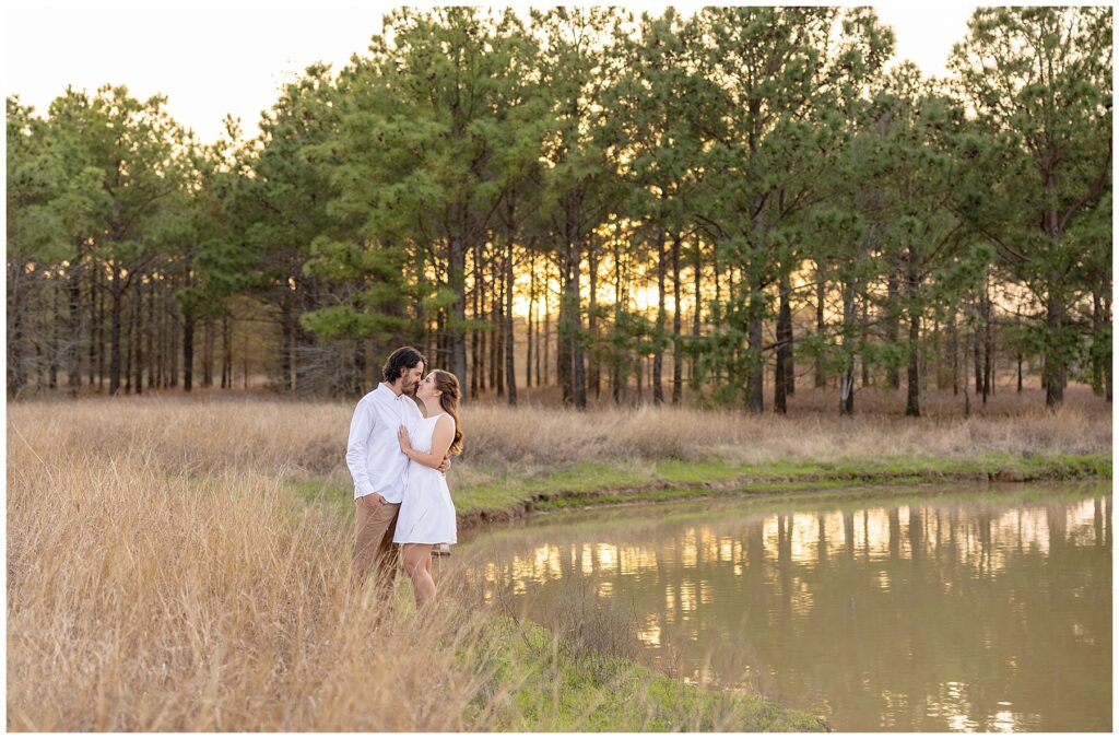"Houston wedding photographer capturing a bride and groom during sunset portraits."

"Photographer in action at a Houston wedding ceremony, taking candid shots of the couple."
"Engaged couple holding hands and walking through a sunlit field at golden hour."

"Man lifting fiancée playfully while laughing during an engagement session."

"Close-up of couple’s hands showing off the engagement ring."

"Couple embracing in front of a scenic city skyline during their engagement session."

"Engaged couple sharing a kiss under a tree with fall leaves surrounding them."
"Engagement session in downtown Houston with couple standing in front of skyline views."

"Couple holding hands while walking through a park in Houston during sunset."

"Engaged couple posing by the water at Hermann Park in Houston."

"Romantic engagement session in a peach orchard near Houston, with soft evening light."